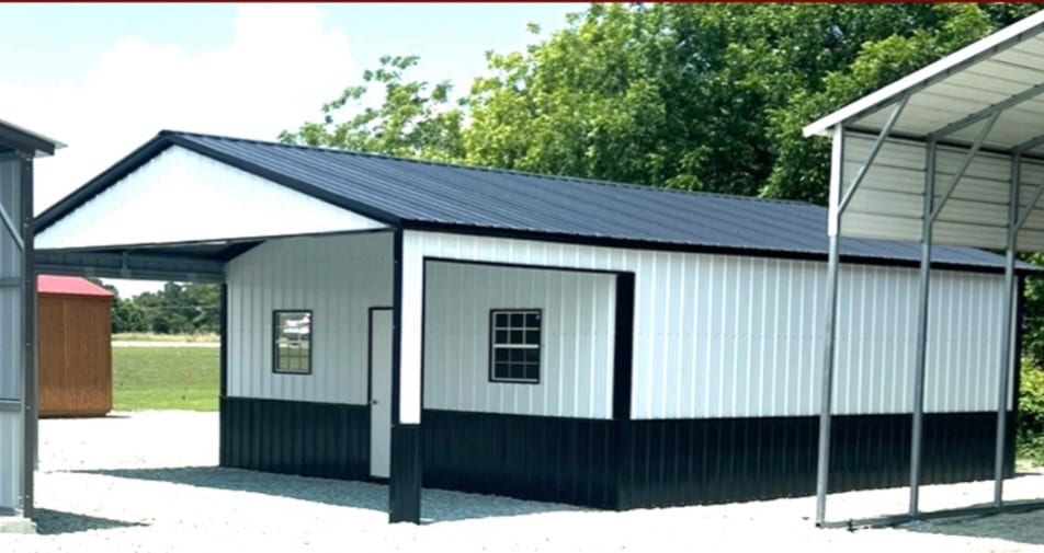 White steel building with a black roof and black wainscot, a window and walk-in door, and an open covered bay along each side